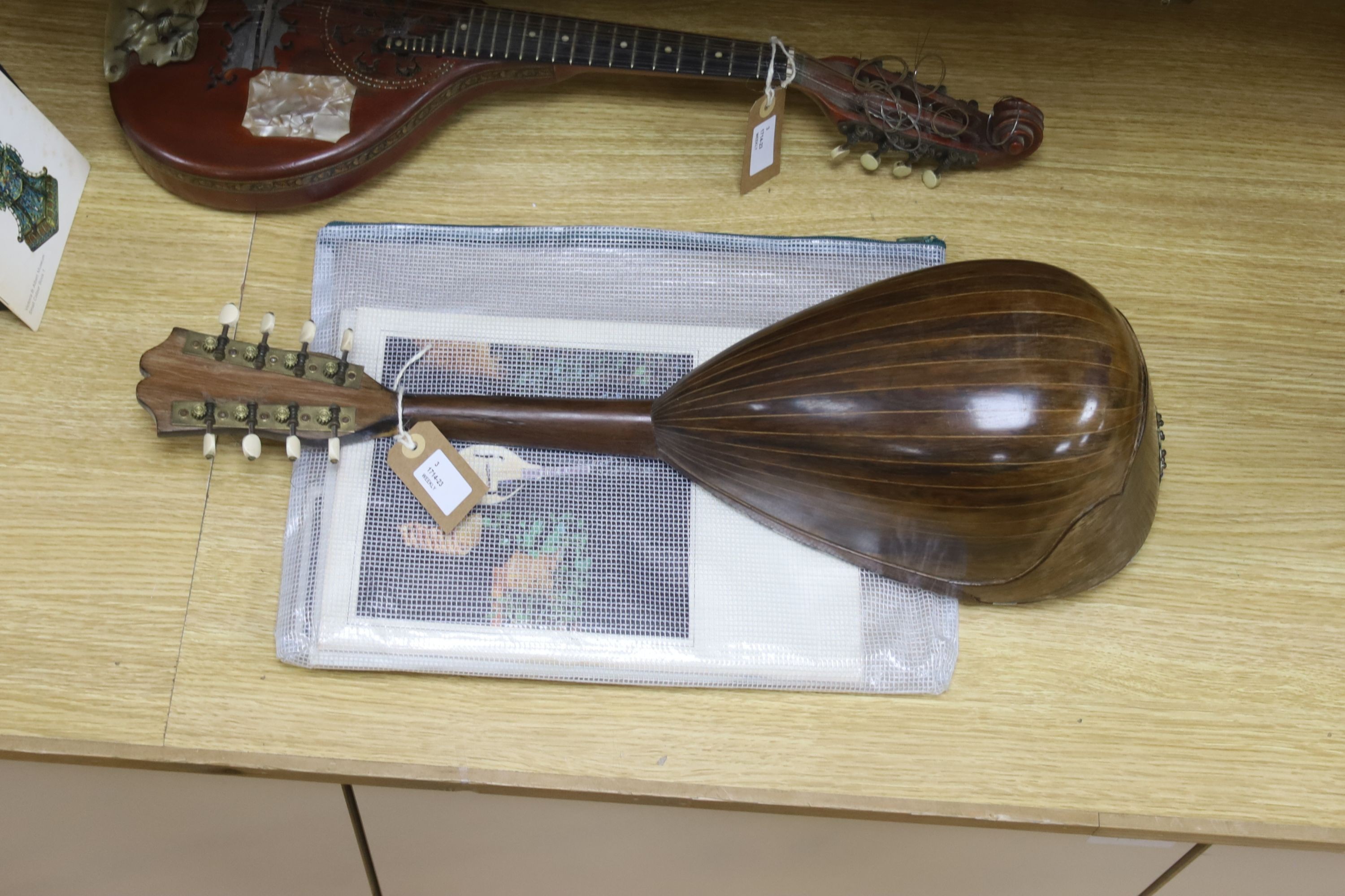 Three Neapolitan mandolins with inlaid mother of pearl decoration, one of round-backed form, the other two archtop